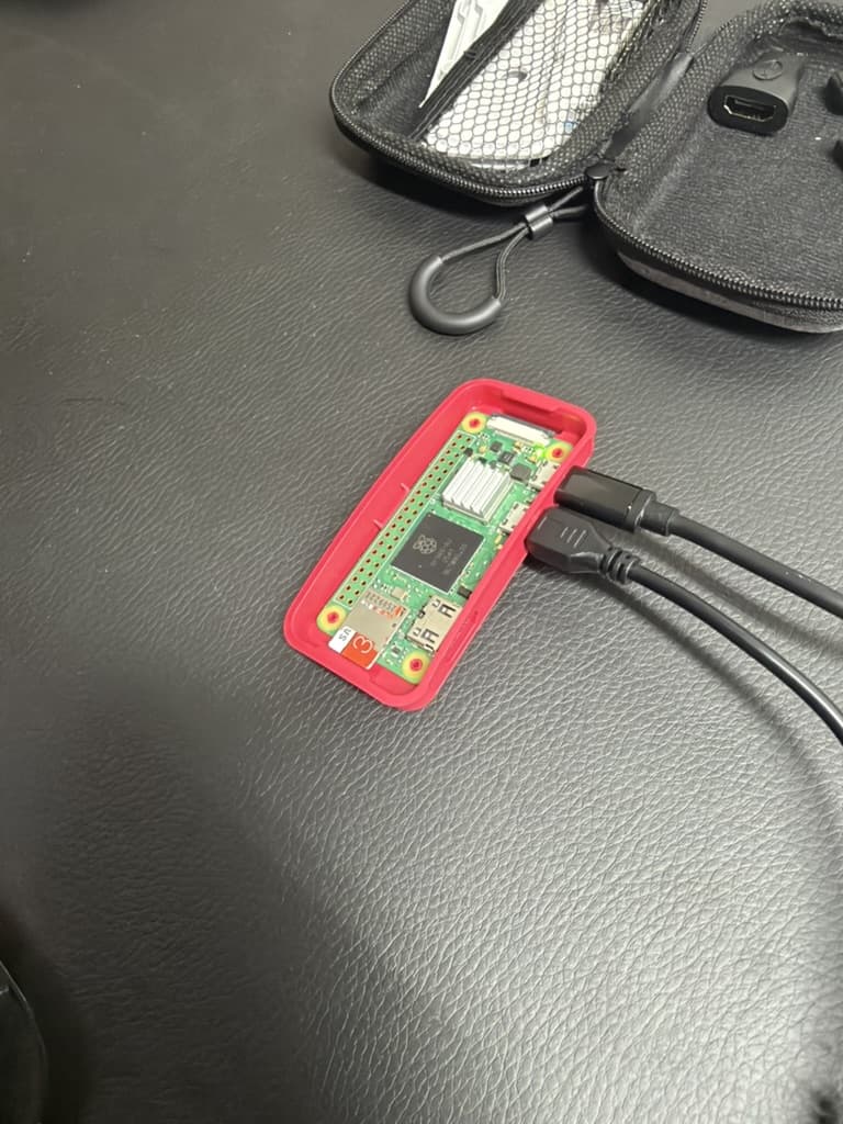 Raspberry Pi Zero 2 W sitting in the bottom half of its red case